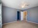 Inviting bedroom with gray walls, ceiling fan, and closet space, providing a relaxing atmosphere at 500 53Rd S St, St Petersburg, FL 33707