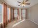 Cozy bedroom boasts carpet floors, large windows, and ceiling fan at 500 53Rd S St, St Petersburg, FL 33707