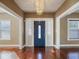 Bright entryway with hardwood floors, chandelier and blue door at 500 53Rd S St, St Petersburg, FL 33707