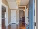 Entryway with hardwood floors, chandelier, and half-bath view at 500 53Rd S St, St Petersburg, FL 33707