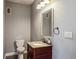 Small half bathroom with toilet, sink, and granite countertop at 500 53Rd S St, St Petersburg, FL 33707