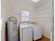 Laundry room with washer, dryer, and ample storage shelving at 500 53Rd S St, St Petersburg, FL 33707