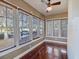 Cozy sunroom filled with natural light from many windows and shiny hardwood floors at 500 53Rd S St, St Petersburg, FL 33707