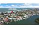 An aerial view of a waterfront home, showing the proximity to a private beach and access parking at 501 Harbor Dr, Belleair Beach, FL 33786