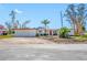 White single story home with red trim, attached garage, and large lot at 5412 Pali Way, St Pete Beach, FL 33706