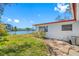 Side view of the home showing AC unit and canal view at 5412 Pali Way, St Pete Beach, FL 33706