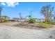 White single story home with red trim and large yard at 5412 Pali Way, St Pete Beach, FL 33706
