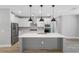 Modern kitchen with a large island, white cabinets and stainless steel appliances at 6141 Dusk Rose Ln, Brooksville, FL 34601
