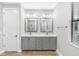 Double vanity bathroom with gray cabinets and quartz countertops at 6141 Dusk Rose Ln, Brooksville, FL 34601