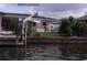 View of a canal from a backyard, showing a boat lift and waterfront property at 8525 42Nd N Ave, St Petersburg, FL 33709