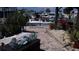 Boat docked at a waterfront property with a brick patio and lush tropical landscaping at 8525 42Nd N Ave, St Petersburg, FL 33709
