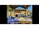 Outdoor patio area with a pergola, seating, and tropical landscaping at 8525 42Nd N Ave, St Petersburg, FL 33709