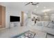 Open concept living room with a TV, sofa and view of the kitchen and stairs at 8607 Canyon Creek Trl, Parrish, FL 34219