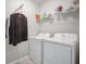 Efficient laundry room features modern washer, dryer, shelving, and storage for easy organization at 8607 Canyon Creek Trl, Parrish, FL 34219