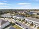 Aerial view of townhouses with lake and surrounding landscape at 8607 Canyon Creek Trl, Parrish, FL 34219