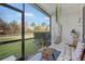 Relaxing screened-in patio with comfortable seating and a view of the green lawn at 8607 Canyon Creek Trl, Parrish, FL 34219