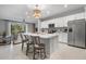 Bright kitchen featuring white cabinets and a large island at 8607 Canyon Creek Trl, Parrish, FL 34219