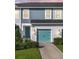 Charming two-story house with teal garage door and landscaping at 8607 Canyon Creek Trl, Parrish, FL 34219
