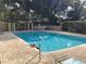 Relaxing community pool with surrounding lounge area at 10196 Sailwinds S Blvd # 107, Largo, FL 33773