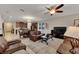 Spacious living room with leather couches and ceiling fan at 11538 Tangle Branch Ln, Gibsonton, FL 33534