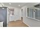 Bright kitchen featuring wood-look floors, white cabinets, and stainless steel refrigerator at 1207 Chevy Chase Dr, Sun City Center, FL 33573