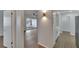 Hallway between the living area and dining area, featuring bright lighting and modern flooring at 1207 Chevy Chase Dr, Sun City Center, FL 33573