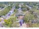 Aerial view of houses with solar panels and lush greenery at 140 Meadowlark Dr, Safety Harbor, FL 34695