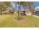 Charming single story home with a manicured lawn and mature trees at 140 Meadowlark Dr, Safety Harbor, FL 34695