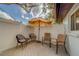 Private patio with seating area, umbrella, and wood decking at 140 Meadowlark Dr, Safety Harbor, FL 34695