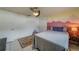 Cozy bedroom with a full-size bed and a unique accent wall at 140 Meadowlark Dr, Safety Harbor, FL 34695