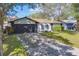 Home with a long driveway and a two-car garage at 140 Meadowlark Dr, Safety Harbor, FL 34695