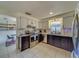 Modern kitchen with stainless steel appliances and stylish dark cabinets at 140 Meadowlark Dr, Safety Harbor, FL 34695