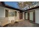 Inviting front porch with wicker chairs and a dark door at 140 Meadowlark Dr, Safety Harbor, FL 34695
