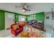 Bright and spacious living room with eclectic decor and a green accent wall at 140 Meadowlark Dr, Safety Harbor, FL 34695