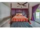 Main bedroom with a post bed, orange bedding, and ceiling fan at 140 Meadowlark Dr, Safety Harbor, FL 34695