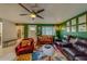 Cozy living room with leather couches and a colorful rug at 140 Meadowlark Dr, Safety Harbor, FL 34695