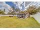 Large grassy backyard with patio and hammock at 140 Meadowlark Dr, Safety Harbor, FL 34695