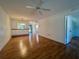Open living area with laminate floors and views into kitchen and bedroom at 1504 Mission Hills Blvd # 19C, Clearwater, FL 33759
