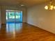 Spacious living room with laminate floors and sliding doors to a screened patio at 1504 Mission Hills Blvd # 19C, Clearwater, FL 33759