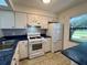 Bright kitchen with white cabinets and blue countertops at 1504 Mission Hills Blvd # 19C, Clearwater, FL 33759