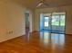 Bright living room with wood-look floors and access to a screened porch at 1504 Mission Hills Blvd # 19C, Clearwater, FL 33759