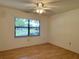 Bright bedroom with wood flooring and a view from the window at 1504 Mission Hills Blvd # 19C, Clearwater, FL 33759