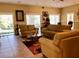 Spacious living room with leather sofas and large windows at 1504 Mission Hills Blvd # 19C, Clearwater, FL 33759