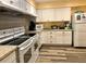 Bright kitchen with updated appliances and granite countertops at 1504 Mission Hills Blvd # 19C, Clearwater, FL 33759