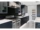 Modern kitchen with dark cabinetry and marble countertops at 2599 W Bay Isle Se Dr, St Petersburg, FL 33705