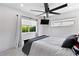Comfortable bedroom with ceiling fan and large window at 2599 W Bay Isle Se Dr, St Petersburg, FL 33705