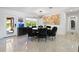 Elegant dining room with a round table, black fur chairs, and large artwork at 2599 W Bay Isle Se Dr, St Petersburg, FL 33705