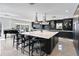 Modern kitchen with large island, marble countertops, and dark cabinetry at 2599 W Bay Isle Se Dr, St Petersburg, FL 33705