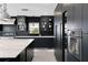 Modern kitchen with marble island, black cabinetry, and high-end appliances at 2599 W Bay Isle Se Dr, St Petersburg, FL 33705