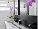 Elegant bathroom with a modern vanity and black tile at 2599 W Bay Isle Se Dr, St Petersburg, FL 33705